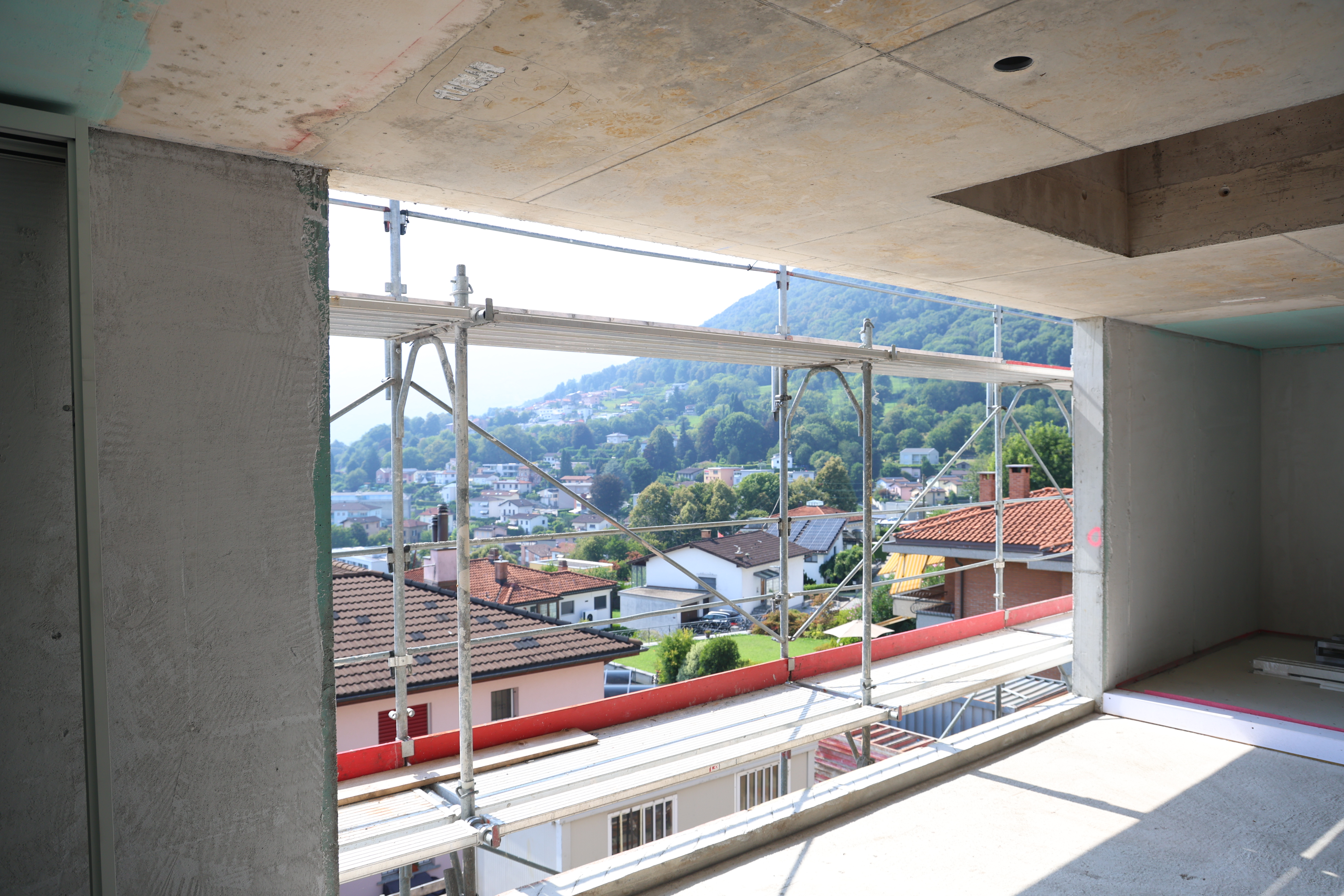 With small homes in stacks below it, this view from the interior of a new building under construction captures the spirit ...